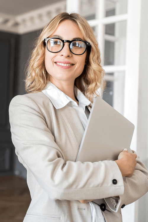 smiling-businesswoman-holding-a-laptop-standing-c-2026-01-08-06-08-28-utc-1.png